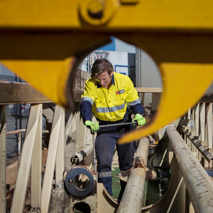 GMS team member maintaining drill rig